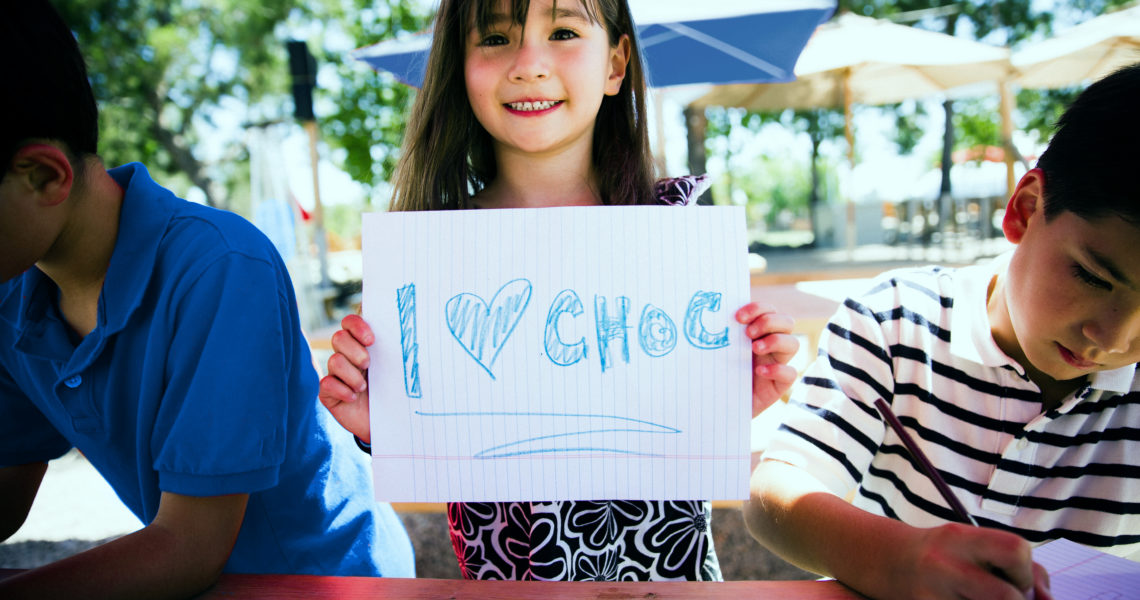 Girl holding I Love CHOC sign