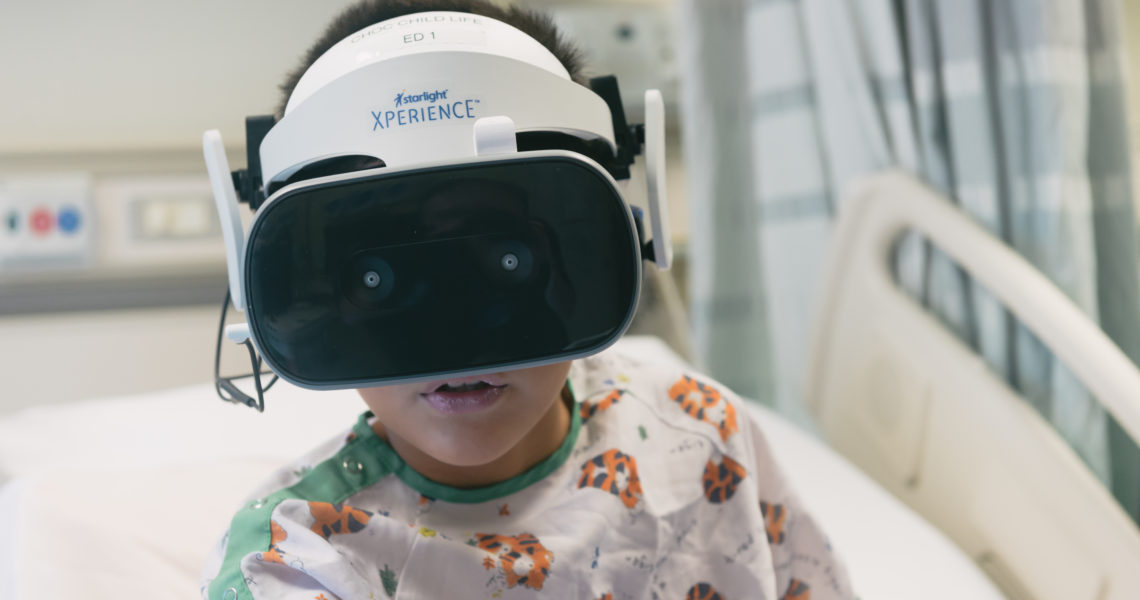 CHOC patient using a virtual reality headset and controller