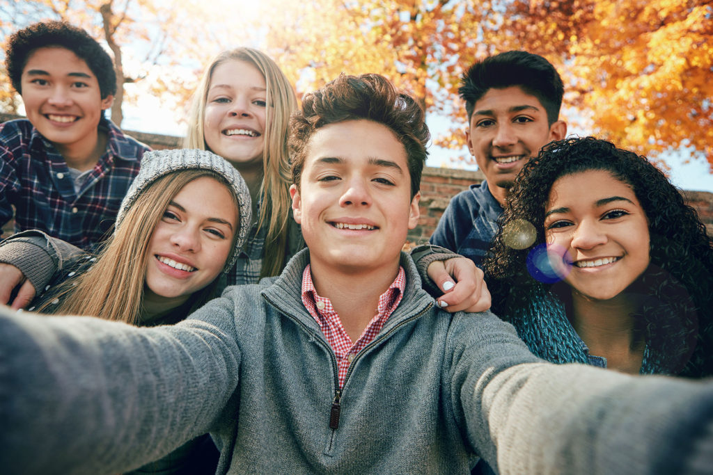Portrait of a group of young people taking a selfie.