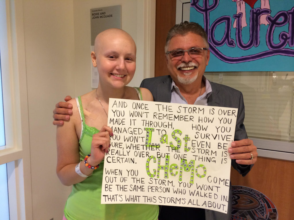 Lauren Aslanian sits next to Dr. Ivan Kirov after her final chemotherapy session. Both are smiling.