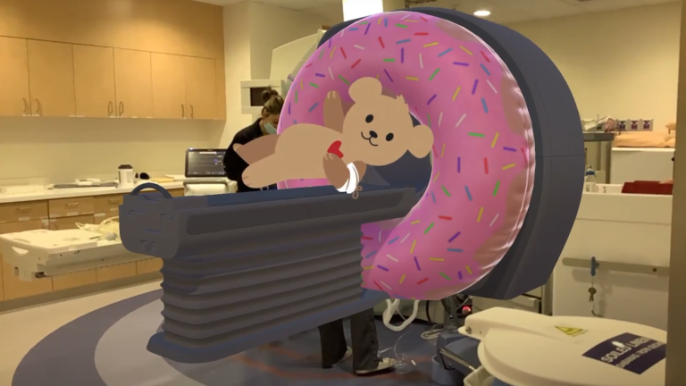 Screenshot of the MRI with Choco app with the augmented reality mascot of the hospital goes through the MRI experience with the patient