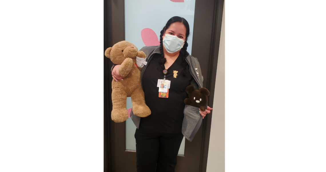 CHOC Associate Veronica in her nurse uniform hollding Choco Bear stuffed toys