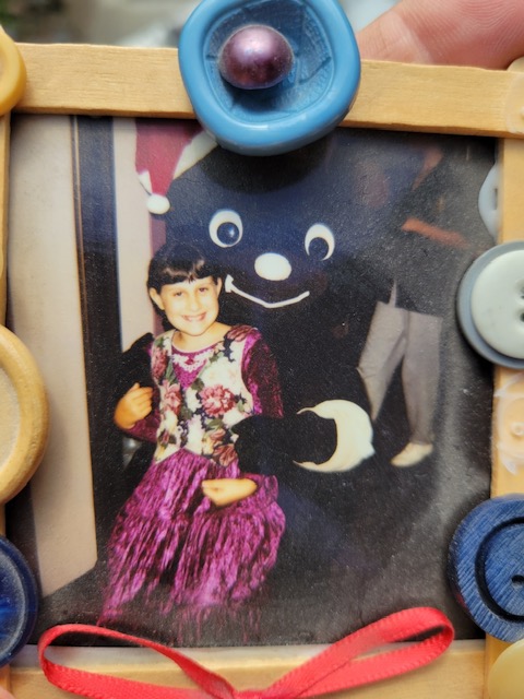 Sarah as a CHOC patient at age seven, pictured with Choco Bear
