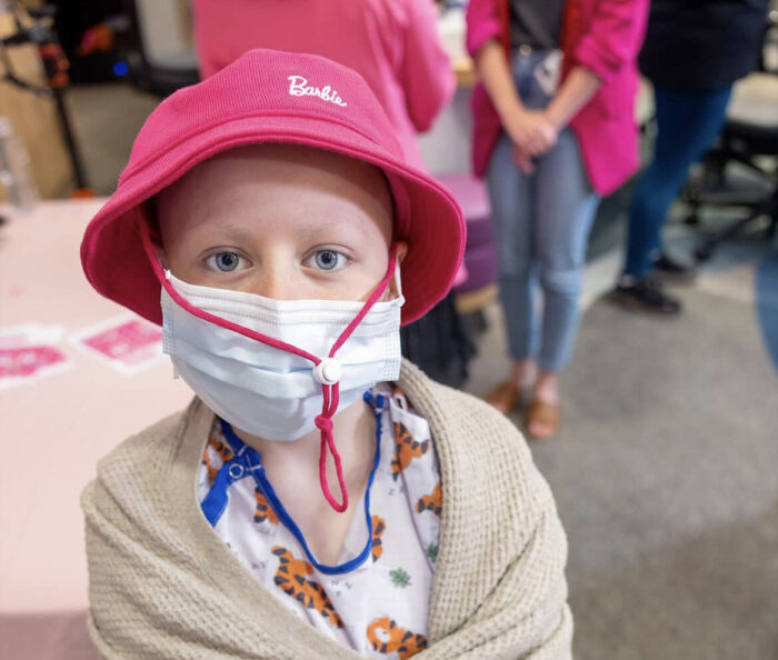 CHOC patient wearing a Barbie pink hat