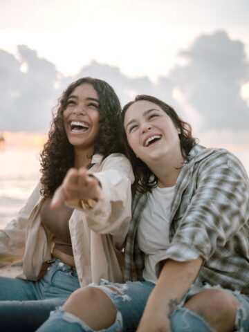 two teenagers laughing in the sunset