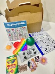 a coping kit for mental health patients at CHOC, which includes a pop-it fidget toy, crayons, stress ball, journal, stickers.