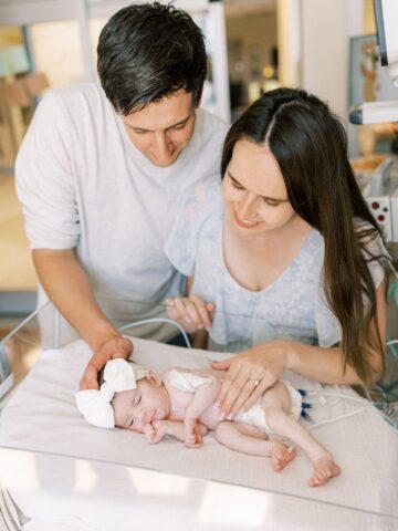 The Kline parents gazing down on their daughter, Emery, at CHOC's neonatal intensive care unit.