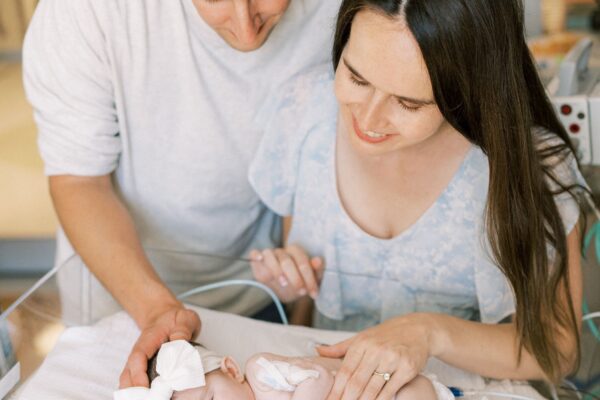 The Kline parents gazing down on their daughter, Emery, at CHOC's neonatal intensive care unit.