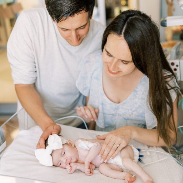 The Kline parents gazing down on their daughter, Emery, at CHOC's neonatal intensive care unit.