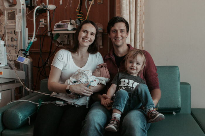 A portrait of the Kline family, including Emery, Courtney (mom), Kevin (dad) and Weston (big brother)