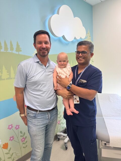 Dr. Ashish S. Chogle holding baby Dylan on her g-tube removal day