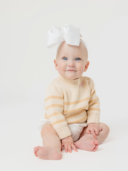 Dylan, pictured with a big bow on her head, smiling