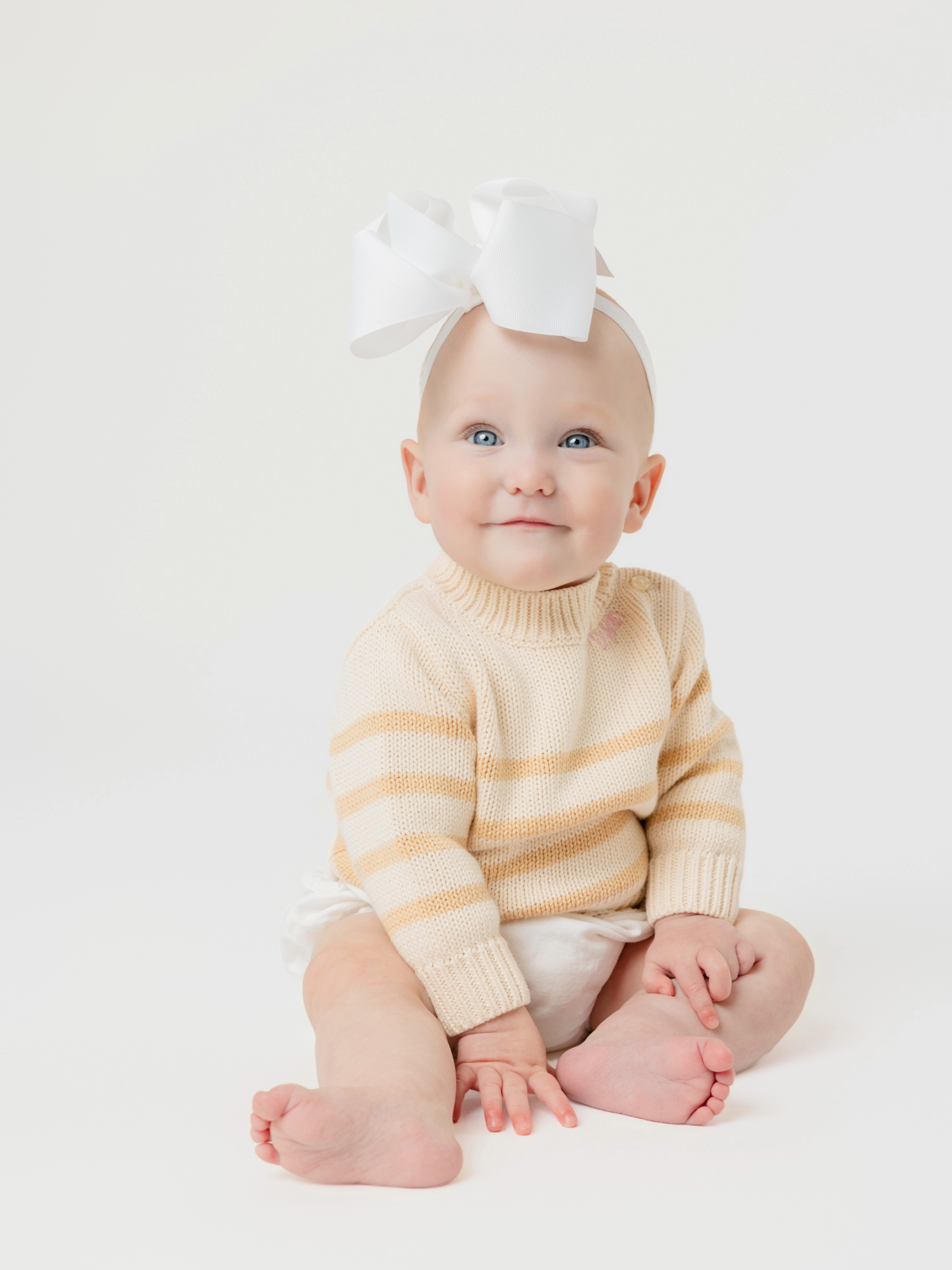 Dylan, pictured with a big bow on her head, smiling